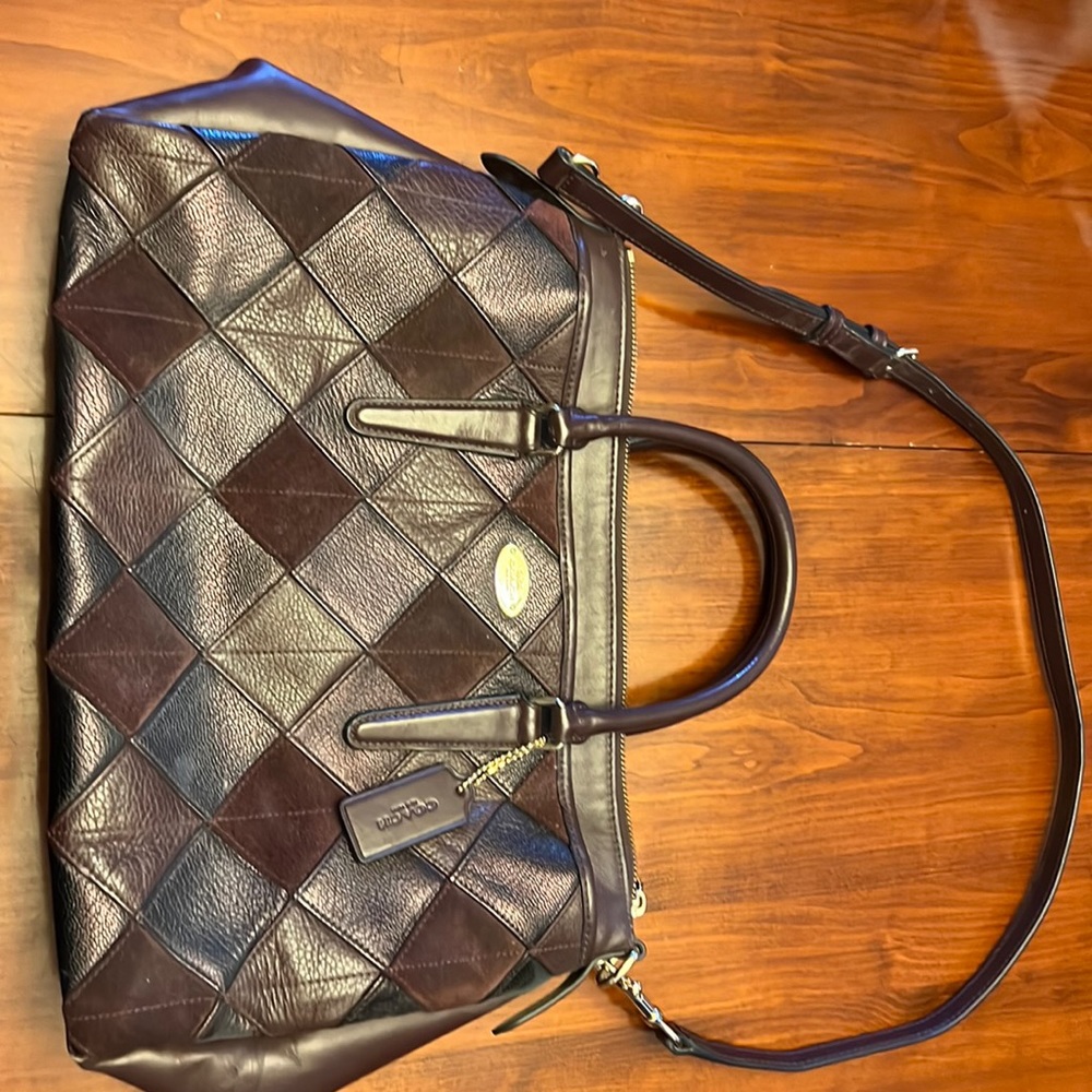 Coach leather/suede burgundy patchwork purse with handles and shoulder strap.